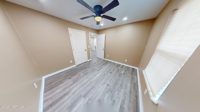 unfurnished bedroom with ceiling fan and light wood-type flooring