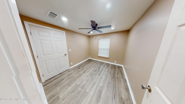 unfurnished bedroom with ceiling fan and light hardwood / wood-style floors