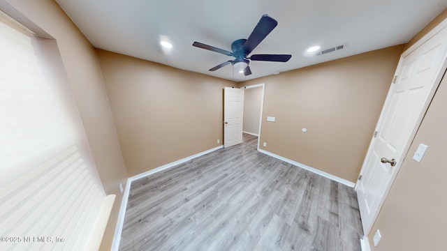 unfurnished room with ceiling fan and light hardwood / wood-style floors