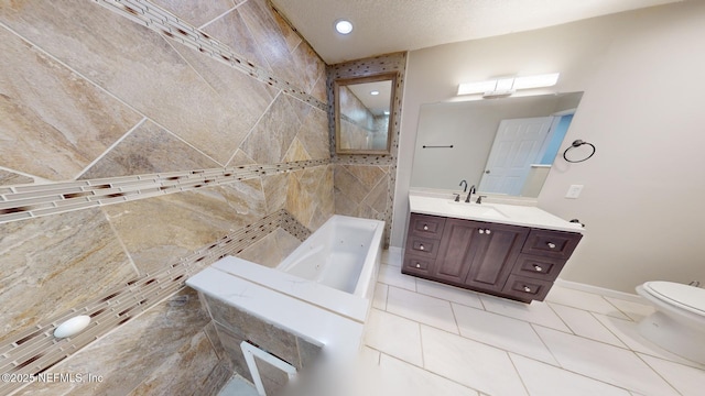 bathroom with vanity, tile patterned floors, a textured ceiling, and toilet