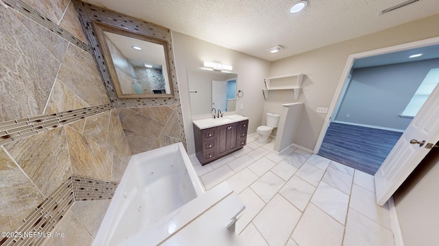 bathroom with vanity, a textured ceiling, and toilet