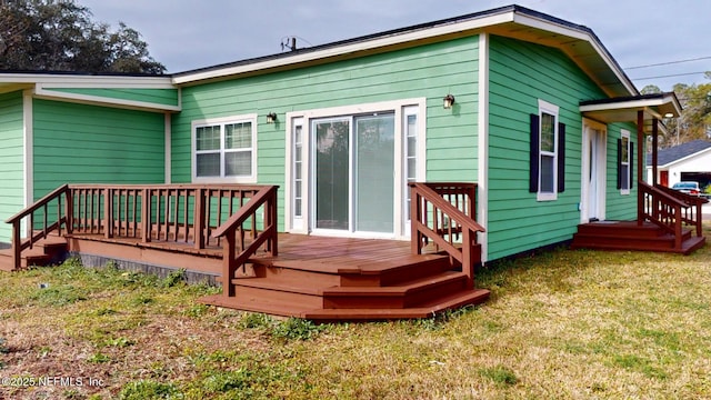 rear view of property featuring a yard