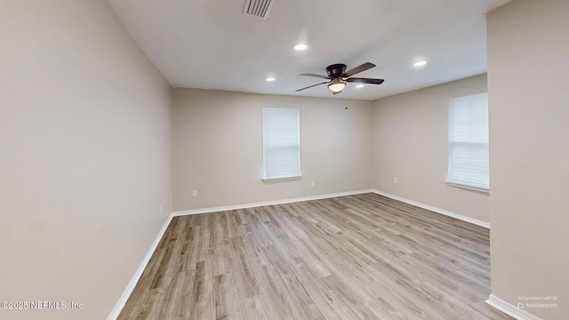 spare room with light hardwood / wood-style flooring and ceiling fan