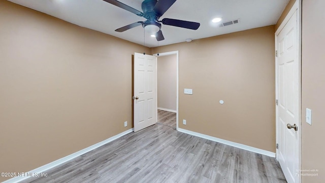 unfurnished bedroom with ceiling fan and light hardwood / wood-style floors