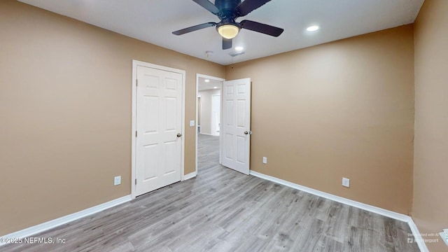 unfurnished bedroom featuring light wood-type flooring and ceiling fan