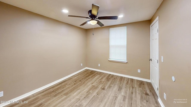 spare room featuring ceiling fan and light hardwood / wood-style flooring