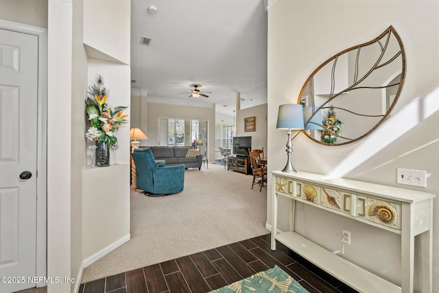 interior space with ornamental molding and ceiling fan