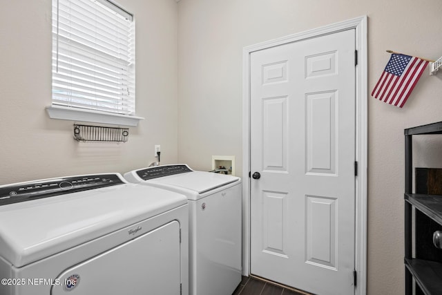 laundry area with dark hardwood / wood-style floors and washer and clothes dryer