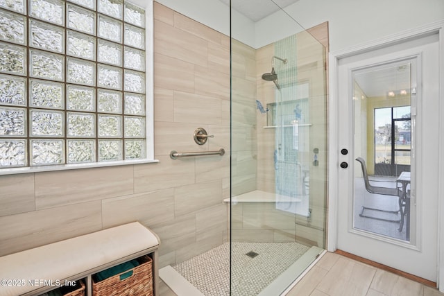 bathroom featuring tile walls and tiled shower