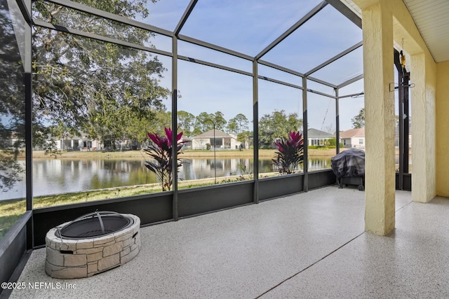 unfurnished sunroom featuring a water view