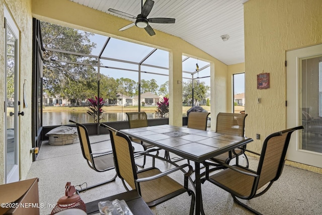 sunroom / solarium with vaulted ceiling, a water view, and ceiling fan