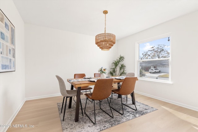 dining room featuring hardwood / wood-style floors and a notable chandelier