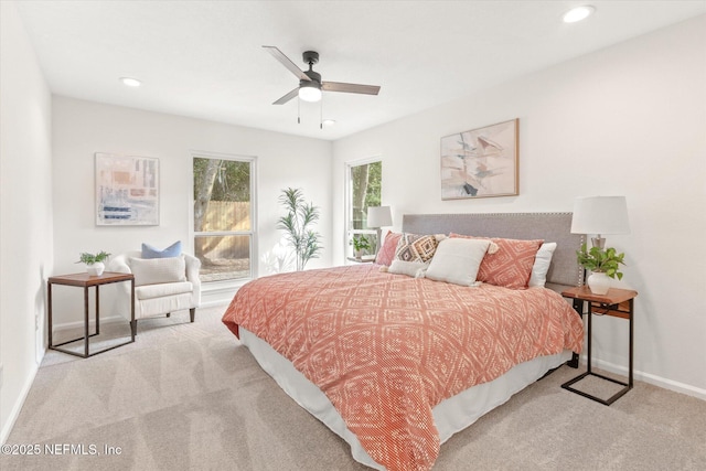 bedroom featuring light colored carpet and ceiling fan