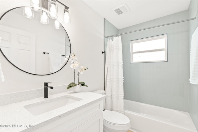 full bathroom with vanity, shower / bath combo, and toilet