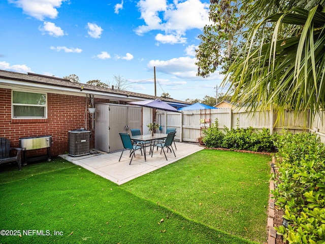 view of yard with cooling unit and a patio area