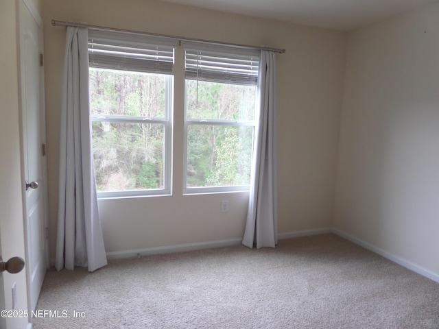 empty room featuring light colored carpet