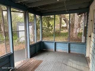 unfurnished sunroom featuring plenty of natural light