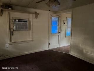 spare room featuring ceiling fan and a wall mounted air conditioner