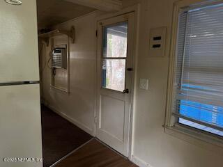 doorway to outside featuring dark wood-type flooring and electric panel