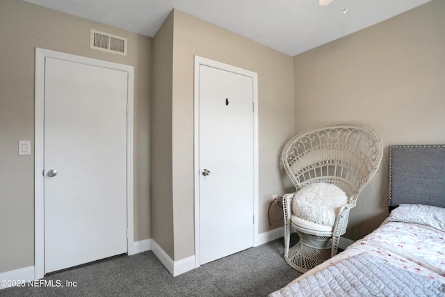 bedroom with dark colored carpet