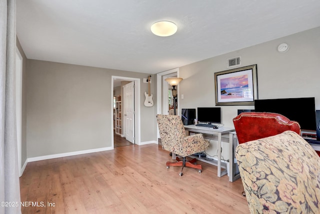 office area with light hardwood / wood-style floors