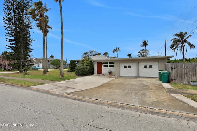 single story home featuring a garage and a front lawn