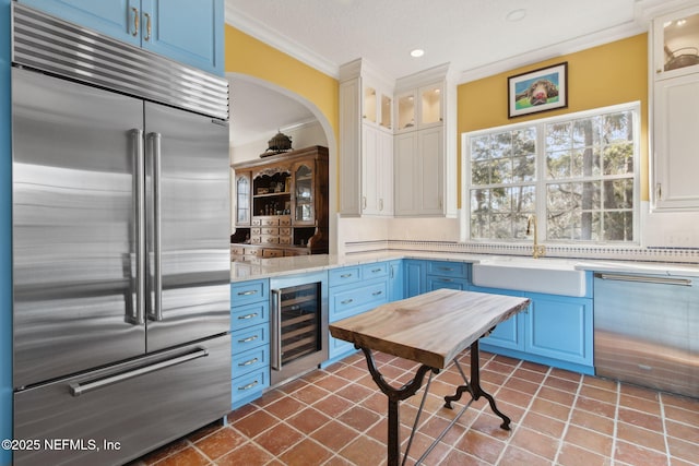 kitchen with white cabinetry, sink, wine cooler, and stainless steel appliances