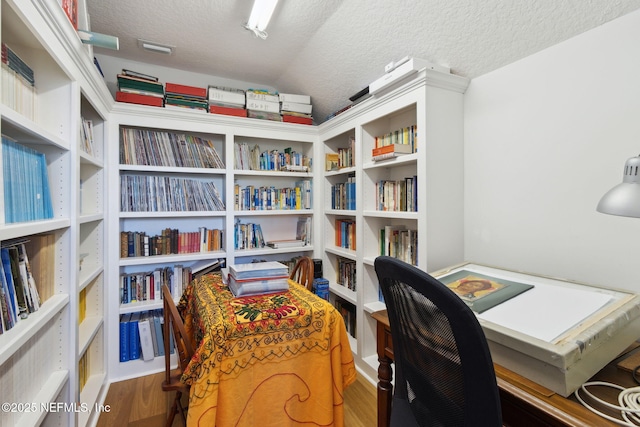 office featuring wood-type flooring and a textured ceiling