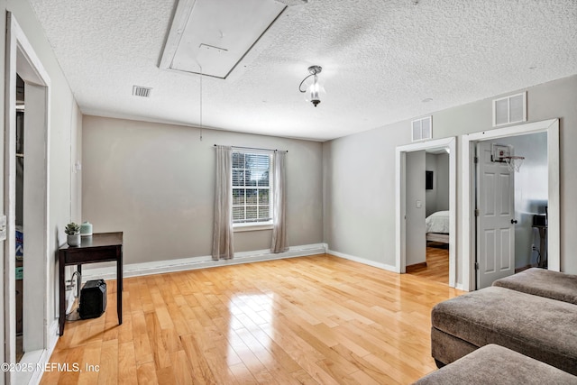 interior space with hardwood / wood-style flooring and a textured ceiling