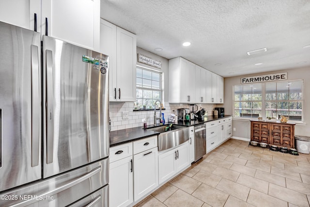 kitchen with appliances with stainless steel finishes and white cabinets