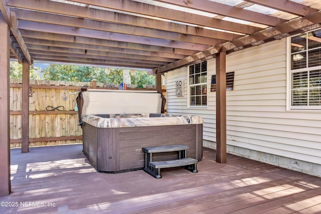 deck featuring a pergola and a hot tub