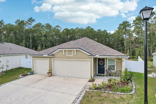 ranch-style house featuring a garage and a front lawn