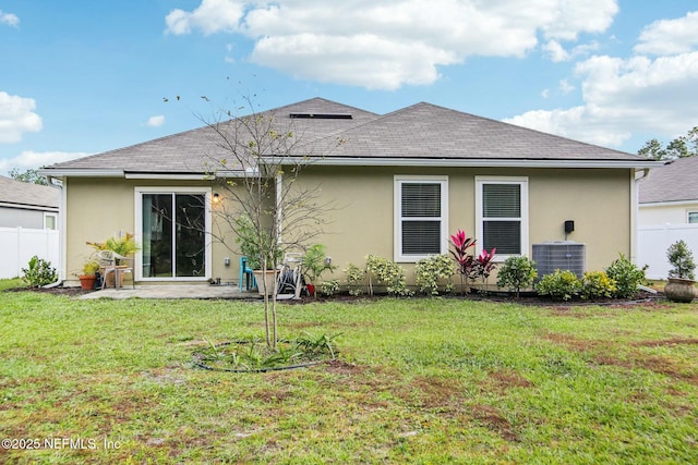 back of house with a yard, a patio area, and central air condition unit