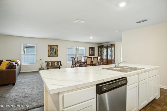 kitchen featuring sink, a kitchen island with sink, white cabinetry, dark colored carpet, and stainless steel dishwasher