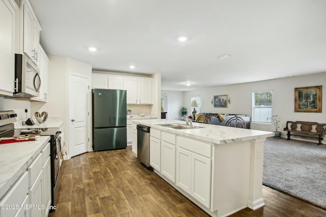 kitchen featuring sink, a center island with sink, white cabinets, and appliances with stainless steel finishes