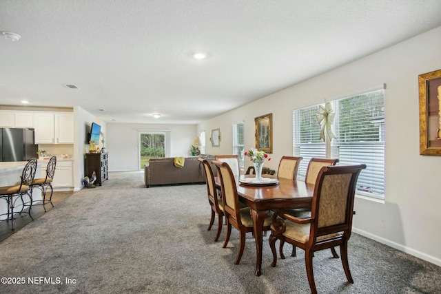 dining space with carpet