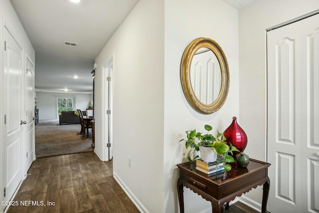 hall with dark wood-type flooring