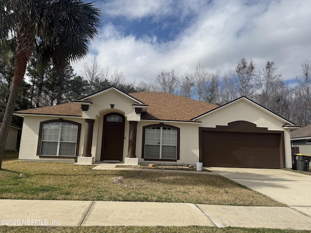 ranch-style home with a garage and a front lawn