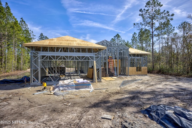 rear view of property featuring an outbuilding