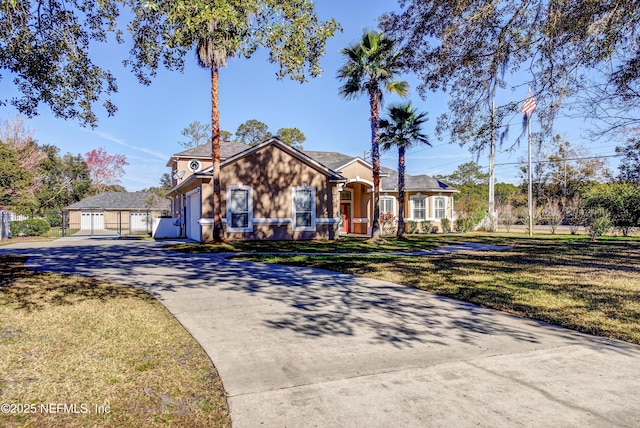 single story home with a garage, an outdoor structure, and a front lawn