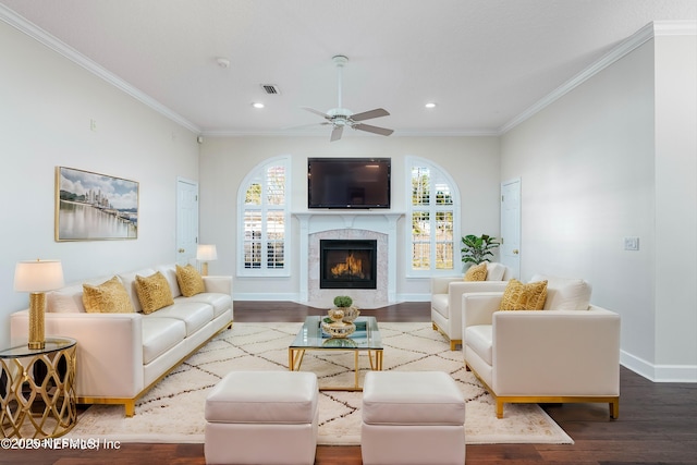 living room featuring hardwood / wood-style floors, plenty of natural light, ornamental molding, and ceiling fan