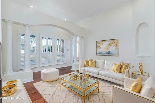 living room with hardwood / wood-style flooring, ornamental molding, and decorative columns