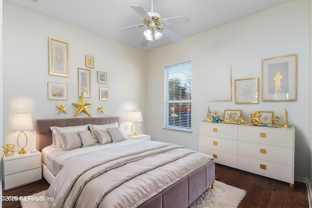 bedroom with ceiling fan and dark hardwood / wood-style flooring