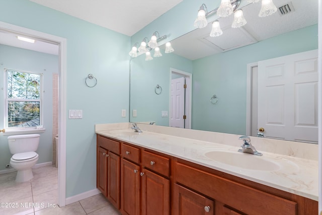 bathroom featuring vanity, tile patterned floors, and toilet