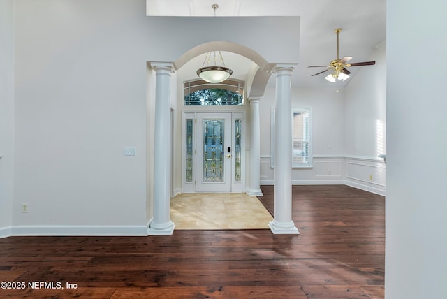 foyer with ornate columns, ceiling fan, lofted ceiling, and dark hardwood / wood-style flooring