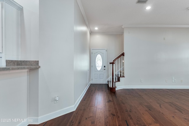 foyer featuring crown molding and dark hardwood / wood-style flooring