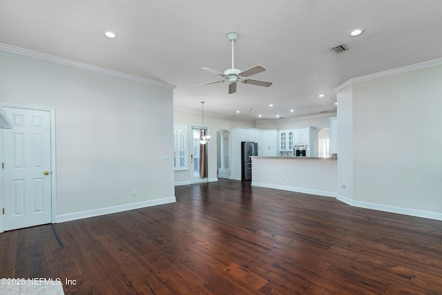 unfurnished living room featuring ornamental molding, dark wood-type flooring, ceiling fan with notable chandelier, and a textured ceiling