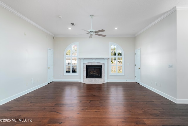 unfurnished living room with ornamental molding, a high end fireplace, dark hardwood / wood-style floors, and a wealth of natural light