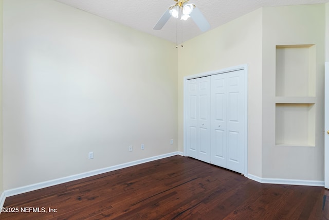 unfurnished bedroom with ceiling fan, a closet, dark hardwood / wood-style floors, and a textured ceiling