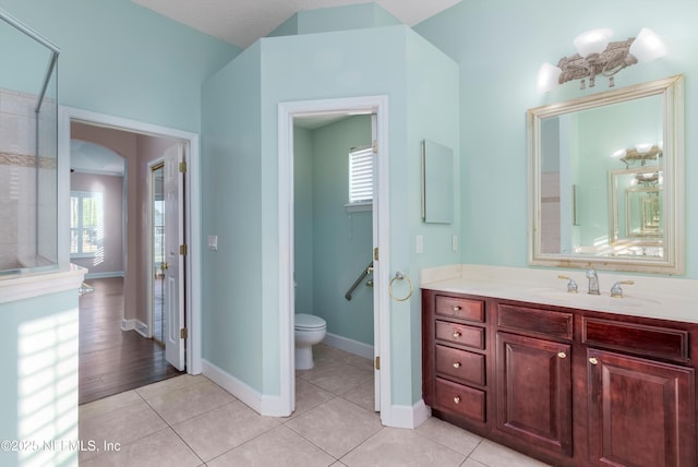 bathroom featuring vanity, tile patterned floors, and toilet